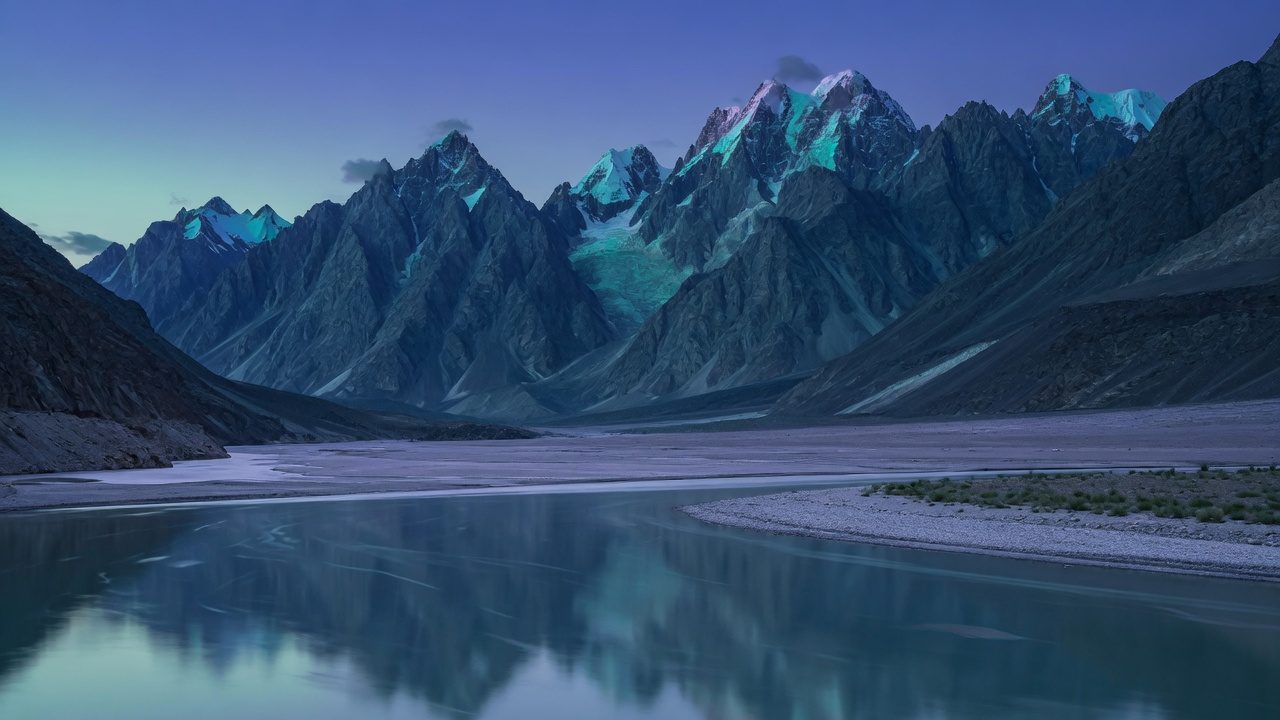 Karakoram peaks above a river at blue hour